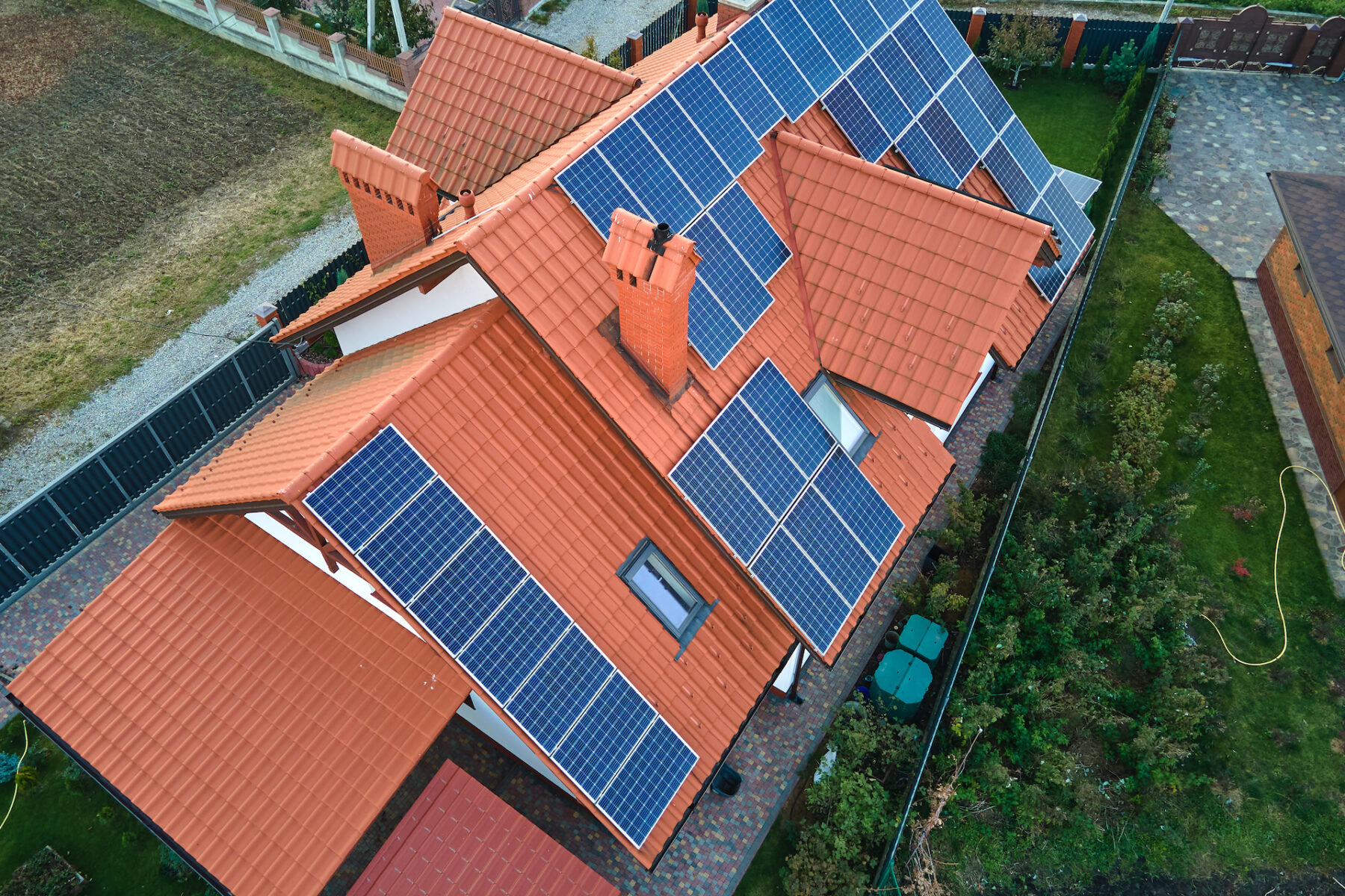 Aerial View Building Roof With Rows Of Blue Solar Photovoltaic Panels For Producing Clean Ecological Electric Energy. Renewable Electricity With Zero Emission Concept